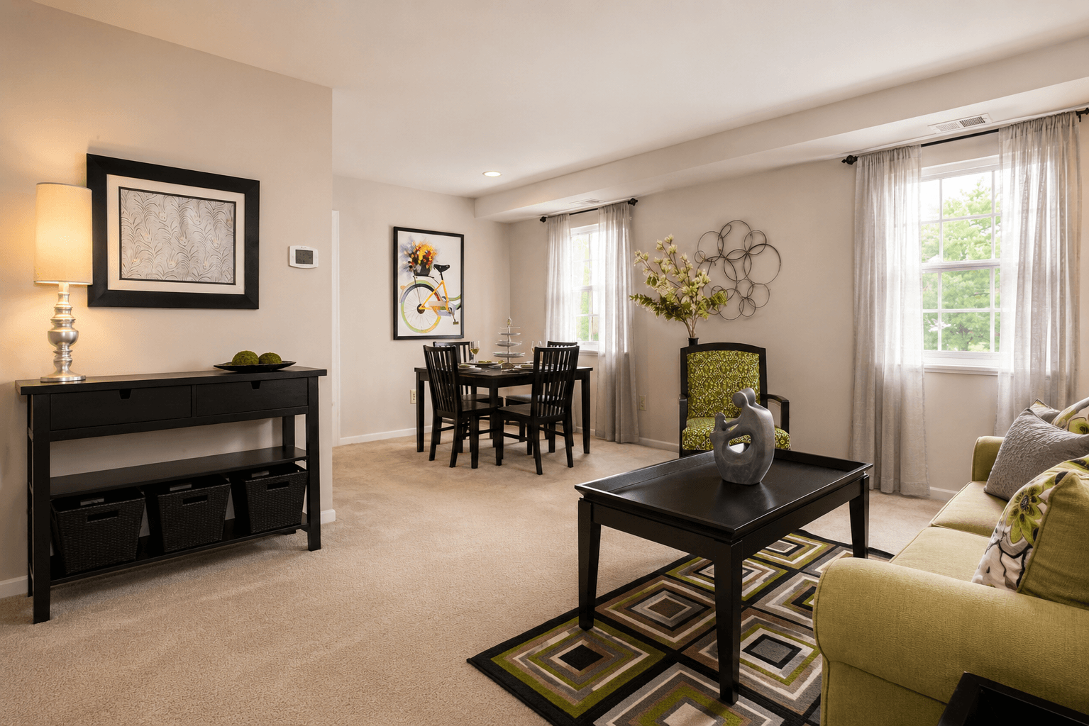 A living room with a black piano, a green couch, and a coffee table.